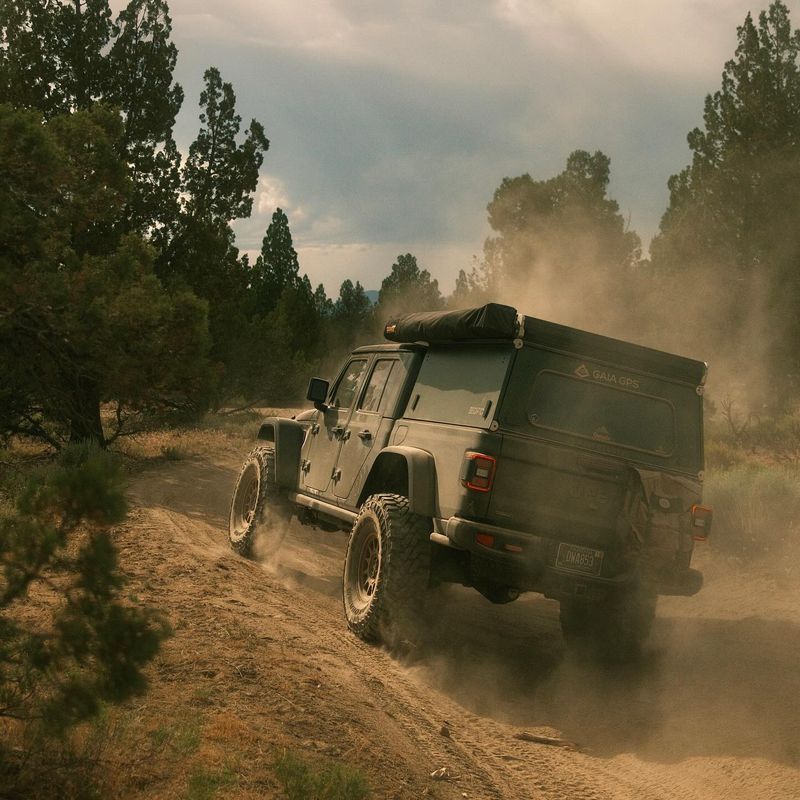 Jeep Gladiator kicking up dust on a forest trail outside Bend. Photo by Andrew Crow