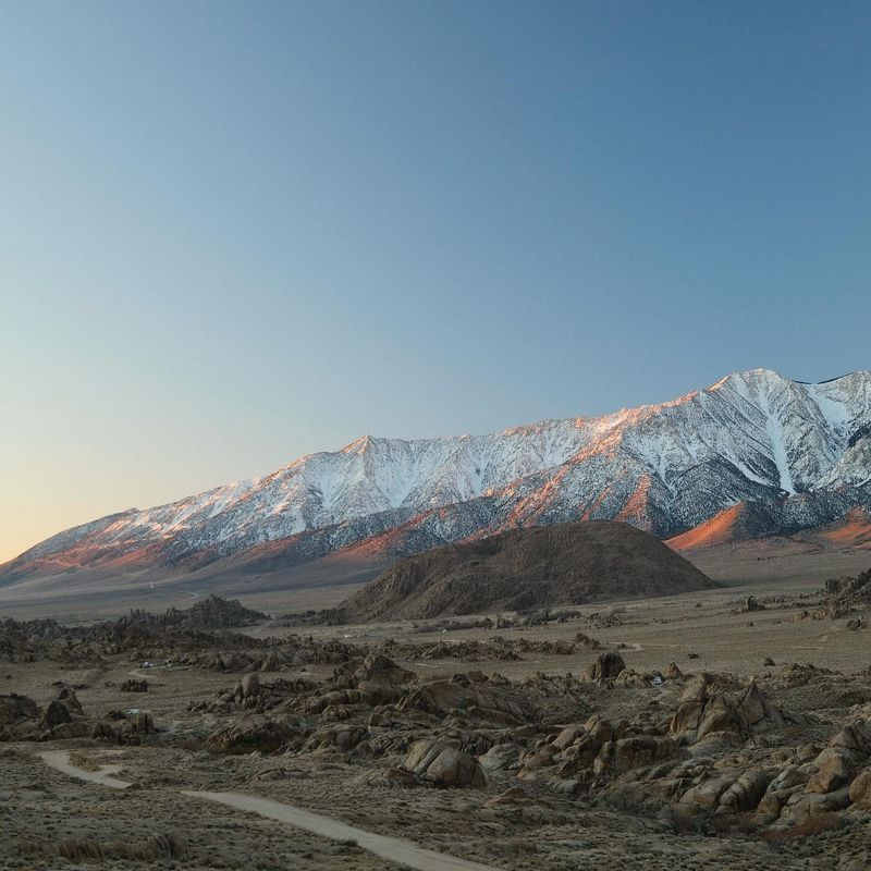 Moon over snowy Sierra peaks and the Alabama Hills. Photo by Andrew Crow