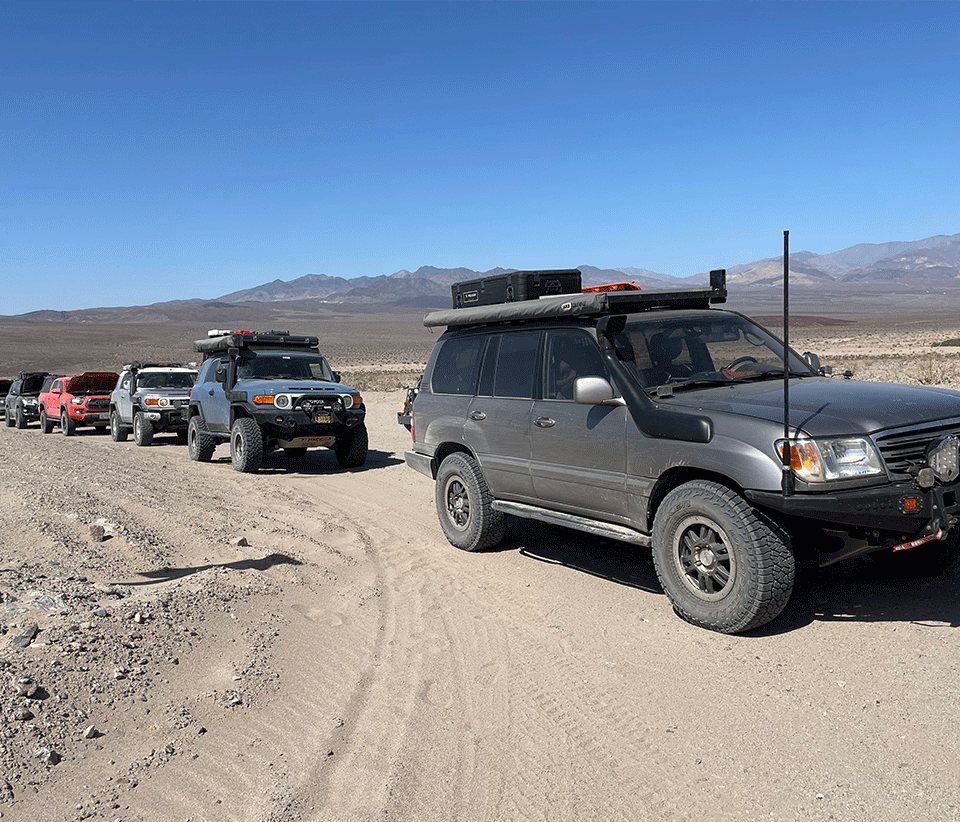 Convoy of rigs on a dry lake road