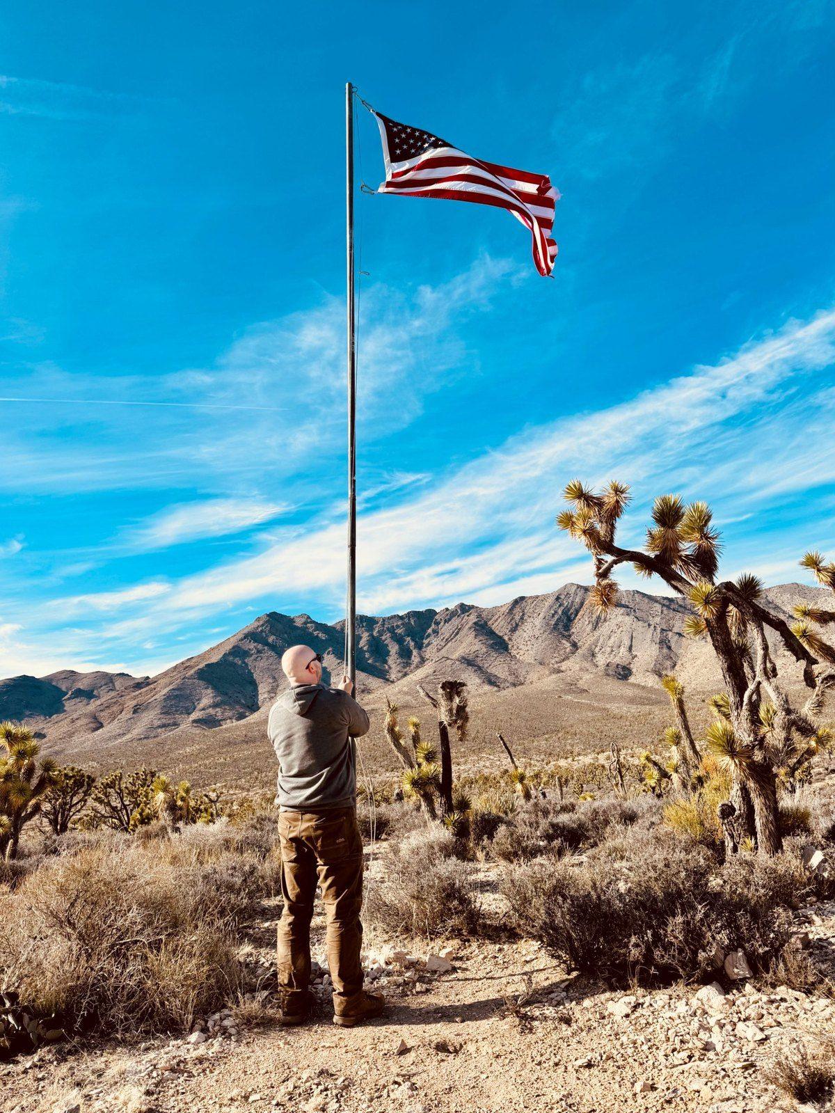 Eric raising the flag at the cabin