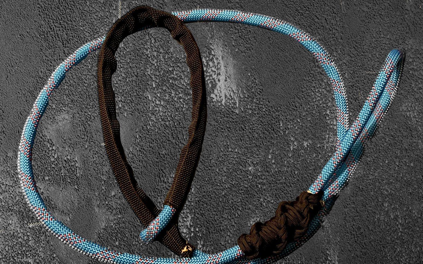 CV Lasso: a blue and white climbing-rope loop with a paracord handle, on dark concrete