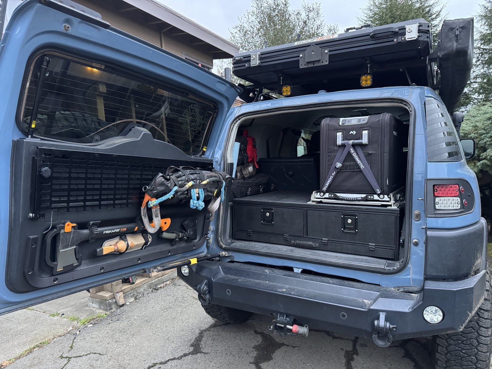 The FJ loaded for a trip, tailgate open, drawers and fridge visible