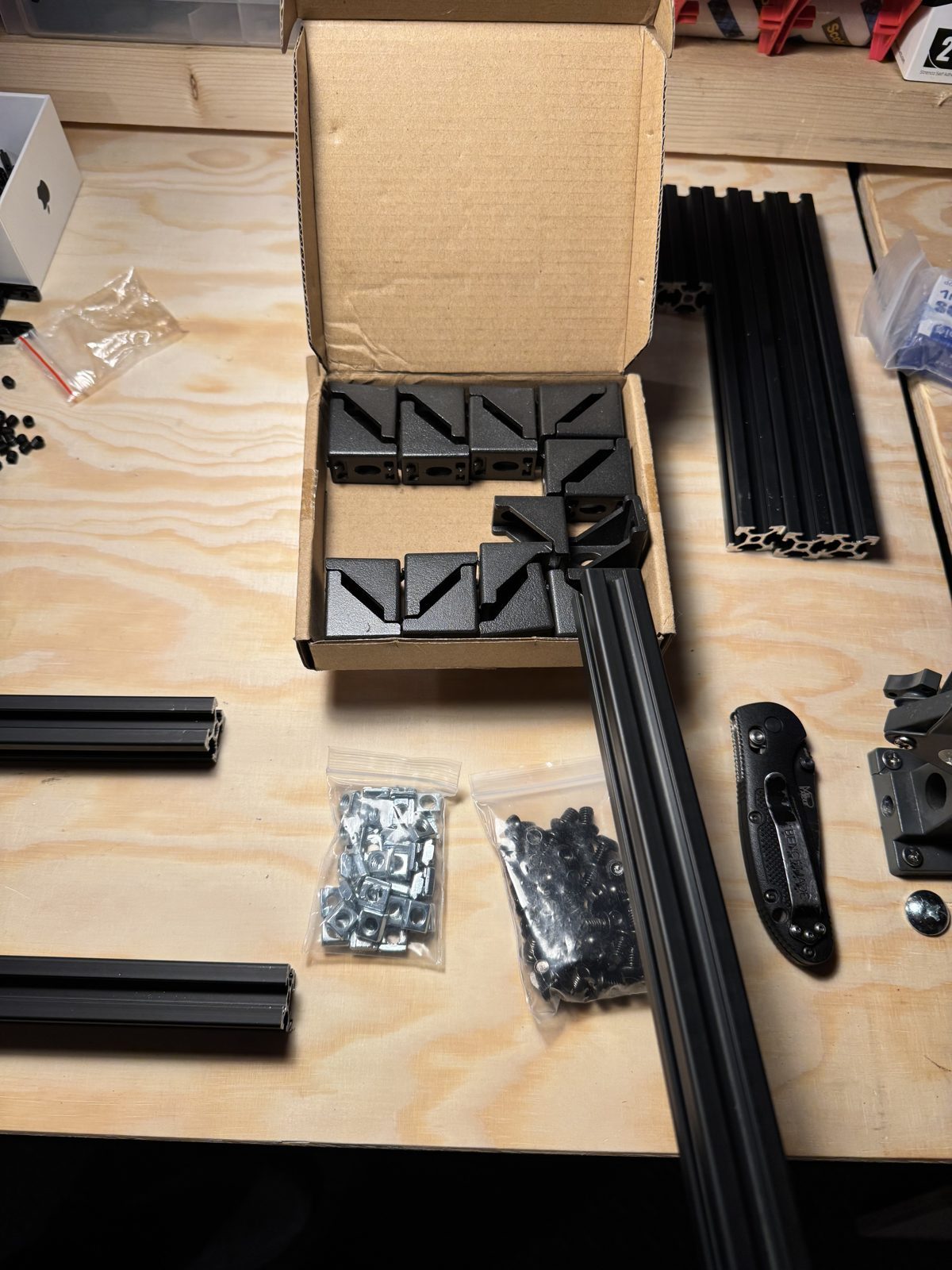Corner connectors, brackets, T-nuts and the first 3-way connector on a rail