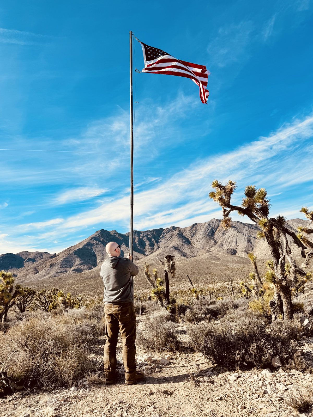 Eric raising the flag beside the cabin