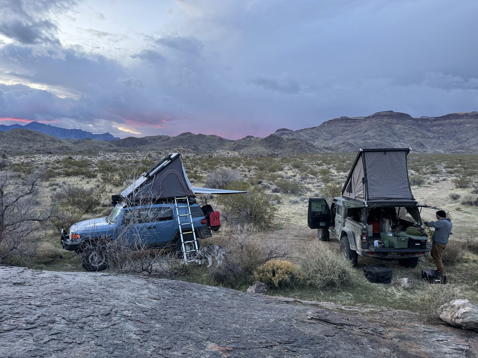 Both rigs camped on slickrock below Hole in the Wall at dusk