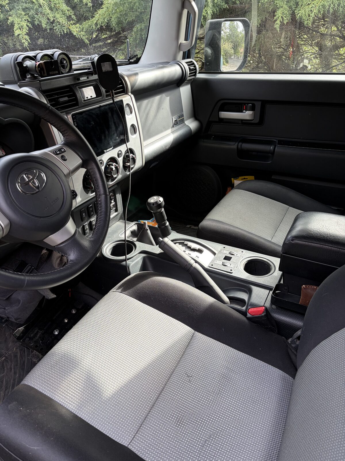 The FJ interior with its stock cloth seats, before the swap