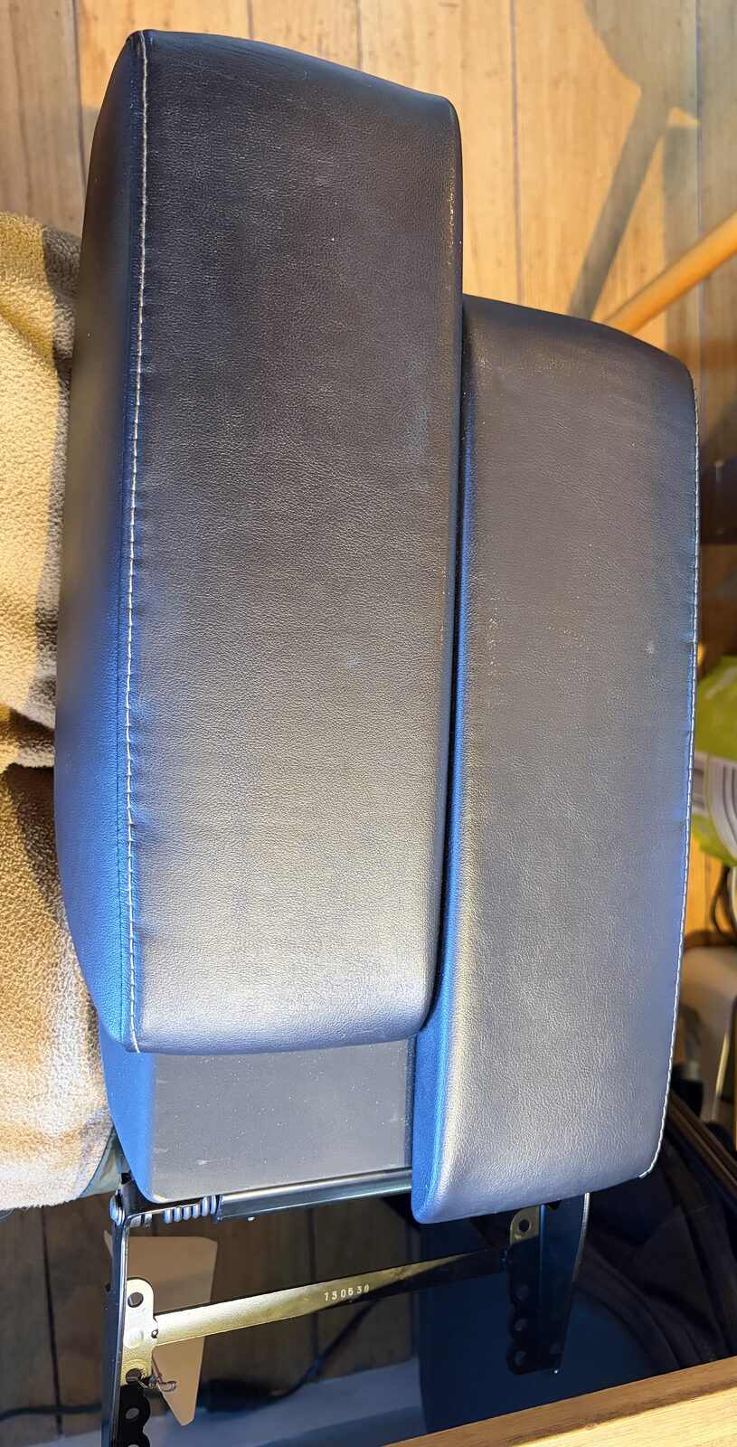 The GX460 console lid off the truck, showing the two independent armrest halves