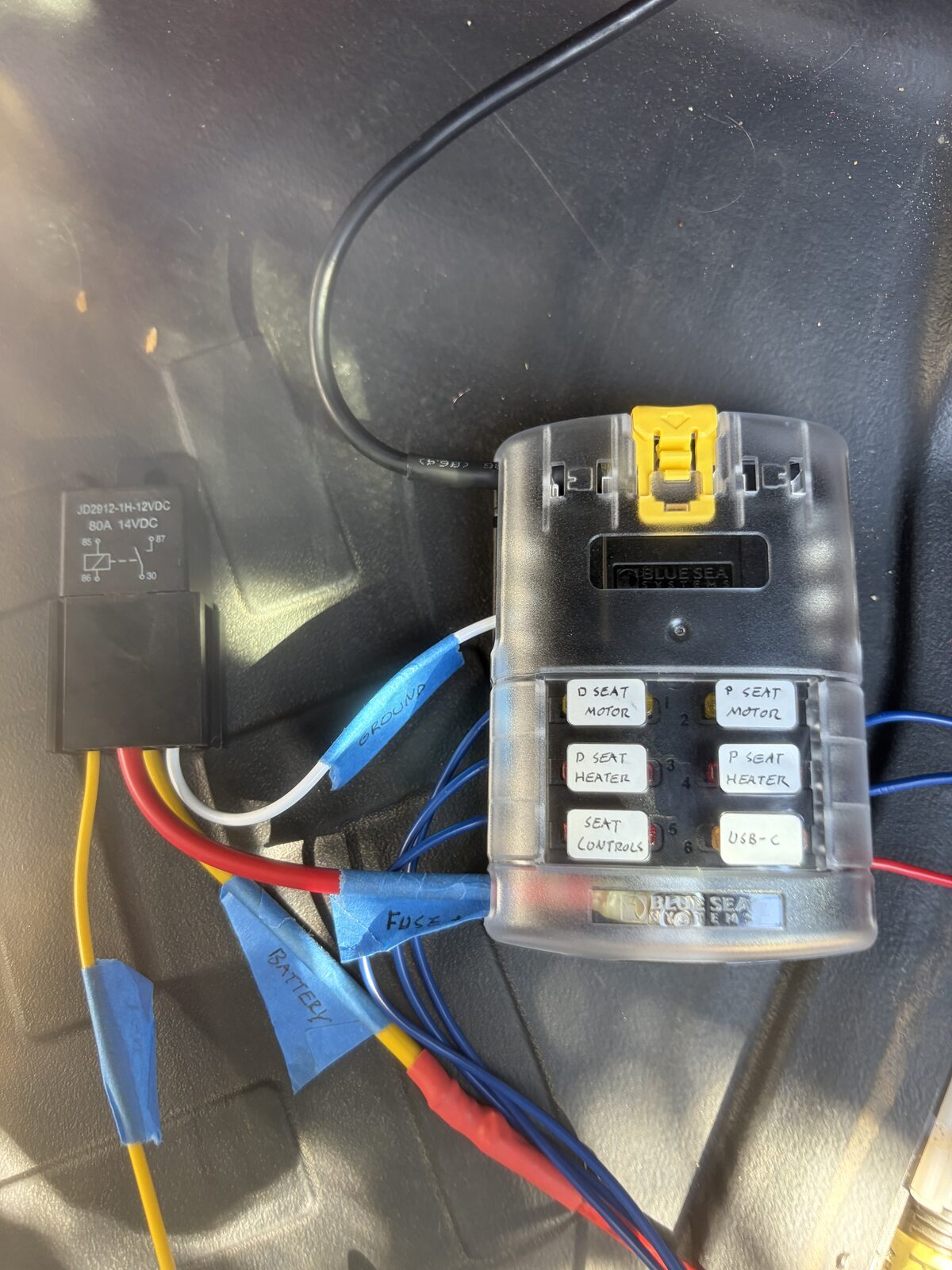 The fuse block mounted with its cover on