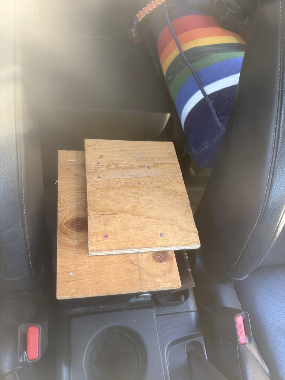 The plywood plate bolted to the top of the Tuffy console before paint
