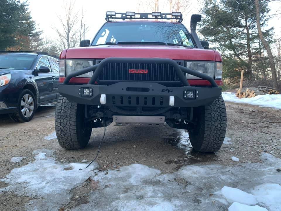 The EAG Jeep XJ bumper on the red Isuzu Trooper, front view, snow on the ground